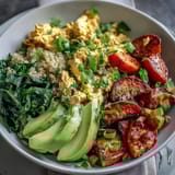 Fork-tender sweet potatoes and creamy avocado top this vibrant Tofu Scramble Vegan Breakfast Bowl.