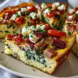 Savory One-Pan Ham and Swiss Frittata loaded with spinach, tomatoes, and nutty Swiss cheese.  