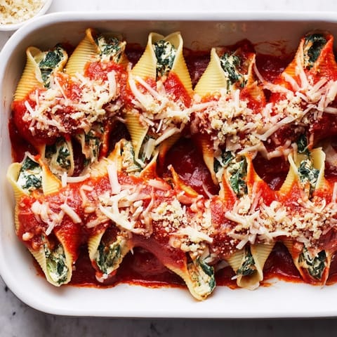 Golden Stuffed Shells fresh from the oven, featuring jumbo pasta topped with bubbly mozzarella and fresh parsley.