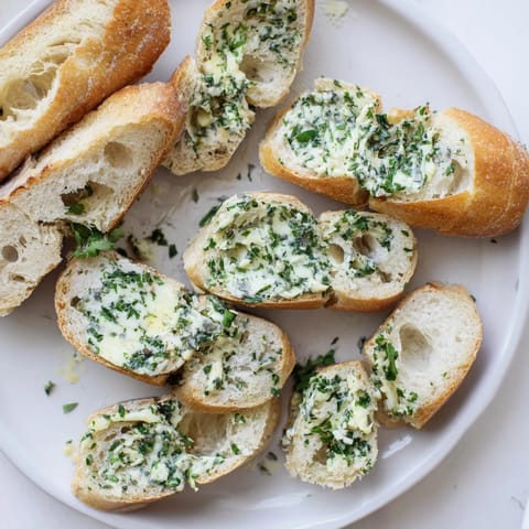 Crusty Garlic Bread topped with fresh parsley, served warm alongside a pasta dinner.