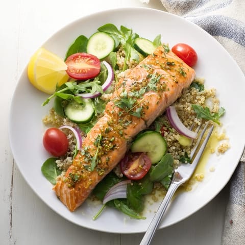 A fresh Lemon Herb Salmon Salad with flaky fillets, fluffy quinoa, crisp veggies, and a tangy lemon dressing.