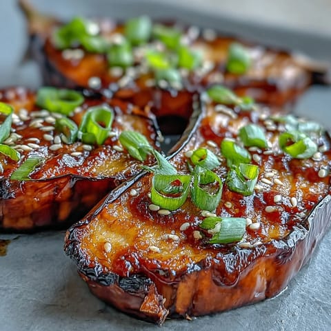 Miso Glazed Eggplant halves, broiled until tender with a glossy, browned umami topping.